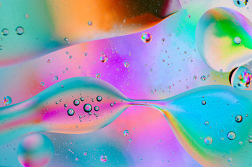 Neon abstract macro background of moving oil drops