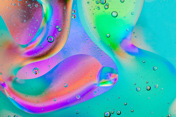 Rainbow neon macro background of oil drops on the water
