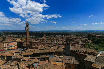 Obraz premium Siena town in Italy and Mangia Tower with the landscape in background 