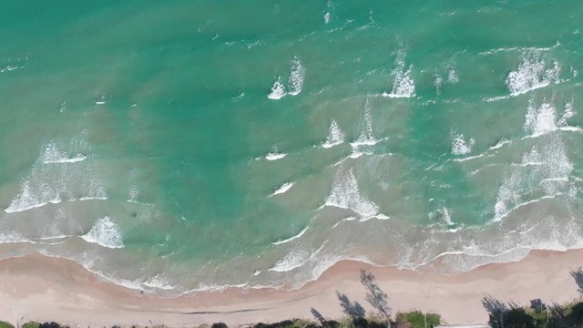 Drone shoots fishing boats on the seashore in Vietnam. Transparent water, the boat as if floating above the ground.