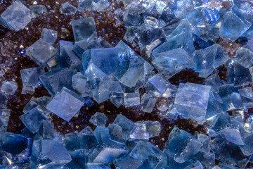 Blue fluorite crystal isolated on the dark background  Blue raw fluorite crystal , macro, close up