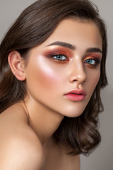 Beautiful young model with a very beautiful colorful smoky eyes, bright blue eyes and natural hairdo
