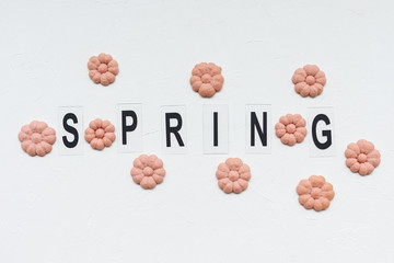 SPRING word and flower cookies on a white background. Spring cooking concept.