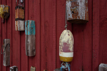 Old retro lobster buoys on the red wall - 300442188