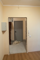 Home renovations with entrance door change, empty doorframe in corridor