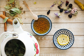 Autumn hot herbal tea with honey, cinnamon and lemon. Top view. Image toned.