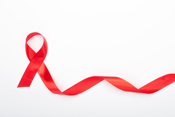 Red ribbon on a white isolated background is the symbol of World AIDS Day.