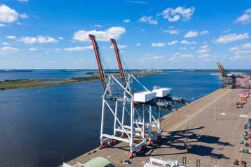 Fototapeta na wymiar Shipping port terminal cranes ready to discharge container ship. 