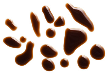 Puddles and spots of tasty soy sauce isolated on white background