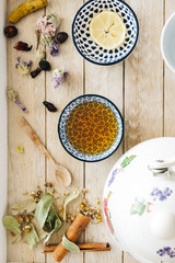 Autumn hot herbal tea with honey, cinnamon and lemon. Top view. Image toned.
