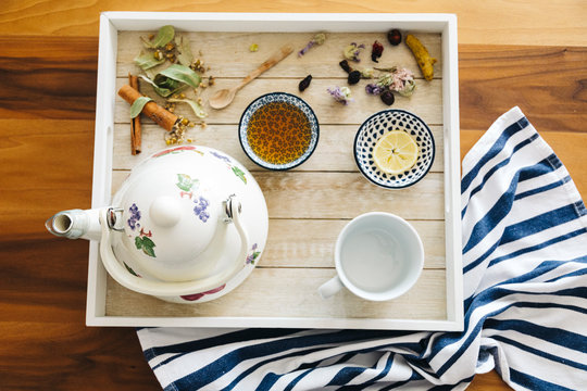 Autumn hot herbal tea with honey, cinnamon and lemon. Top view. Image toned.