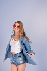 Full length side profile photo. beautiful lady, stylish hairstyle in jeans denim shorts isolated on blue background