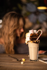 Girl holding cocktail  in the restaurant. Alcoholic drinks.
