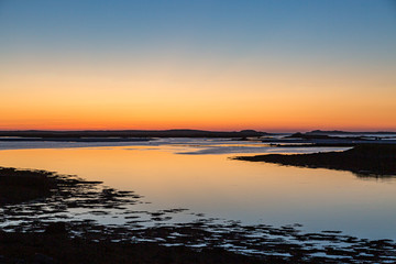 A dramatic sunset over the water, viewed from near the causeway between Benbecula and North Uist