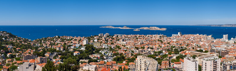 Naklejka na ściany i meble Panoramic summer view on Marseille rooftops with Ile du Frioul and Ile d'If and the Mediterranean Sea. Bouches-du-Rhône (13), Provence-Alpes-Cote d'Azur, France, Europe