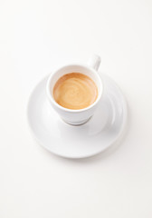 Cup of coffee isolated on white paper background. Close up. 