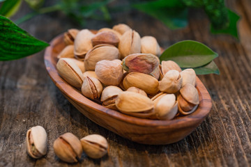 Pistachios on a wooden table.