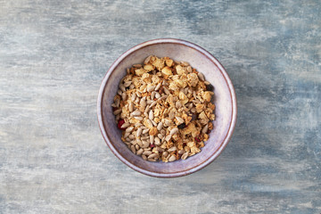 Bowl of granola. Concept for a tasty and healthy meal. Rustic wooden background. Top view. Copy space. 