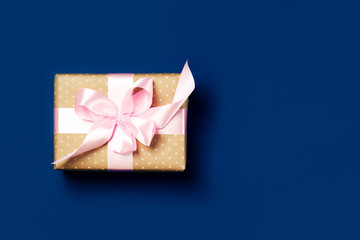 Luxurious gift on a trendy blue colors. Copy space. Present for St. Valentine's day, weddings, engagements, Mother's Day, birthday, New Year, Christmas, holidays