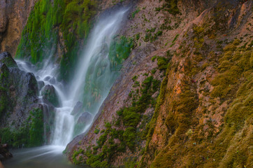 Close detail of Pisoaia waterfall streaming down through the moss in Apuseni Mountains, Transylvania, Romania