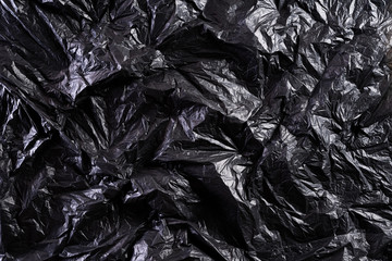 Top view of Black plastic bag texture and background. Reduction of plastic bags for natural treatment. Recycle and World Environment Day concept.