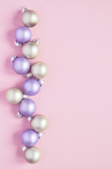 Christmas holiday background with decorations for the Christmas tree, balls of pastel colors on a delicate pink trend background.