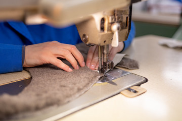 Sewing details of fur and leather. Shoe production.