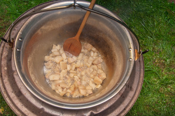fried bacon in a stainless steel pan