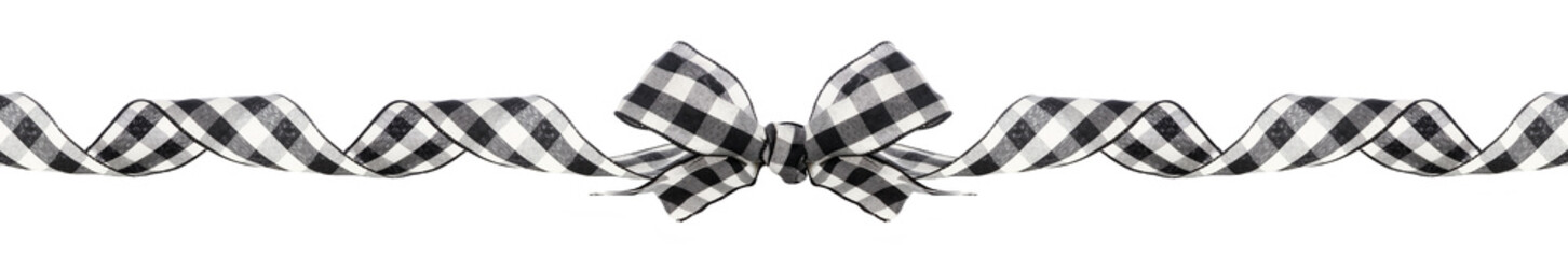 Long Christmas border of black and white buffalo plaid bow and ribbon isolated on a white background