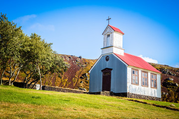 Fototapeta na wymiar Traditional quaint Icelandic corrugated iron church with red roof