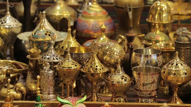 Traditional oriental souvenirs. Coated vases and coffee pots. Multi-colored lamps and secular decorations. Eastern market in Oman. Souvenirs and traditional goods