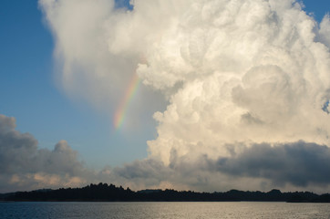 Naklejka na ściany i meble Lake, rainbow and amazing clouds