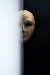 Composition with half of the paper masks on a light gray background with a delicate bouquet of...