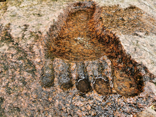 The imprint of a person's foot in granite. Footprint on the ground of the yeti. The imprint of the...