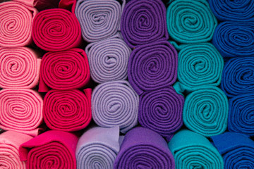 abstract background of rolled blankets in different colors