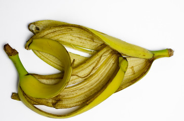 Not fresh banana peel lying on isolated white background.
