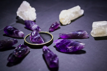 Top view on purple amethysts and white quartz on dark background