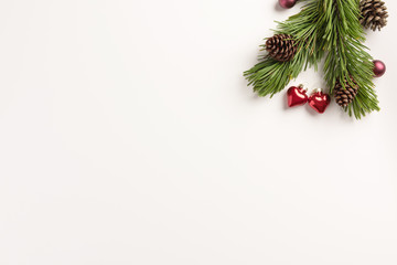 Christmas composition. Spruce branches with small hearts, on a white background. Christmas, winter concept. Flat lay, top view, copy space.
