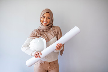 Young Muslim contractor woman wearing a protective helmet. Business middle east woman put hijab...
