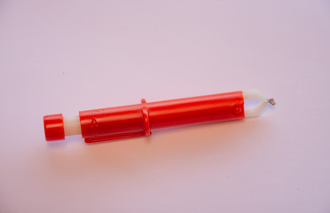 Red  Extractor for removing ticks,TICK TWISTER in a hand