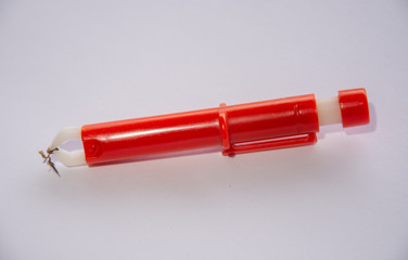 Red  Extractor for removing ticks,TICK TWISTER in a hand