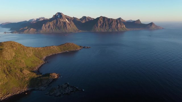 aerial view. flight over the sea,view on the Flakstadoya from Haukland beach and Mannen peak. Camera move left to right .Lofoten Islands,Norway