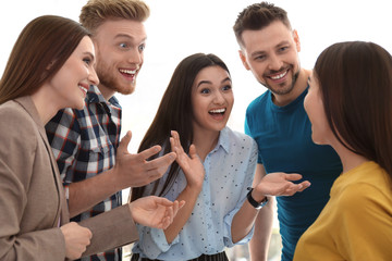 Group of happy people talking in light room