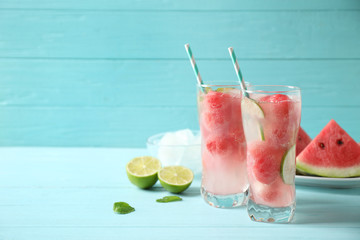 Delicious refreshing watermelon drink on blue wooden table. Space for text