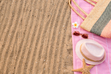 Composition with beach accessories on sand, flat lay. Space for text