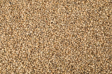Organic hemp seeds as background, top view