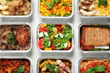 Lunchboxes on white wooden table, flat lay. Healthy food delivery