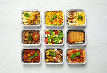 Lunchboxes on white wooden table, flat lay. Healthy food delivery