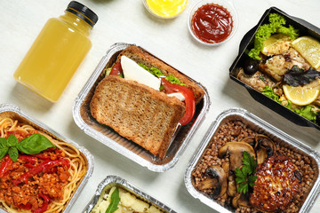 Lunchboxes on white wooden table, flat lay. Healthy food delivery