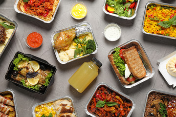 Lunchboxes on grey table, flat lay. Healthy food delivery